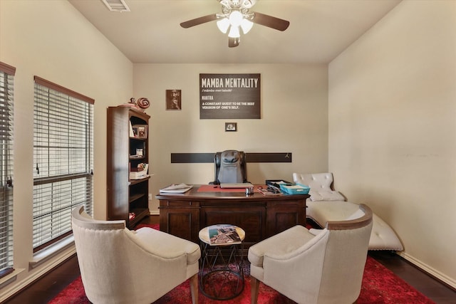 office with dark hardwood / wood-style floors, a healthy amount of sunlight, and ceiling fan