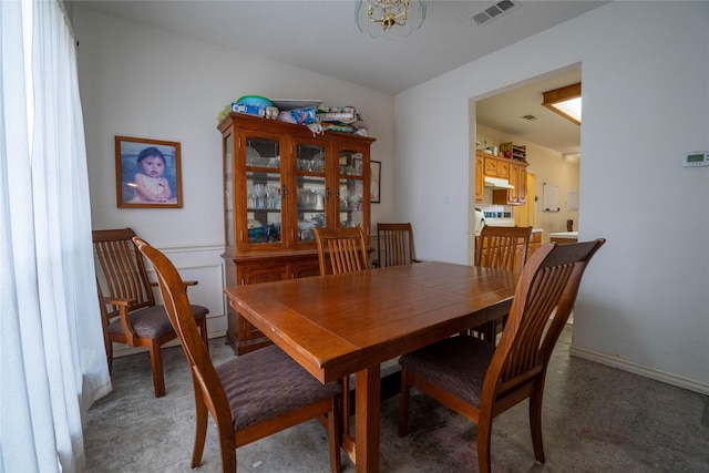 dining space featuring a notable chandelier