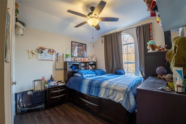 bedroom with a textured ceiling, dark hardwood / wood-style floors, vaulted ceiling, and ceiling fan