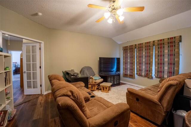 living room with french doors, a textured ceiling, vaulted ceiling, and ceiling fan