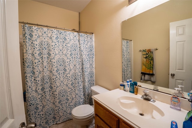 bathroom with vanity, toilet, and a textured ceiling