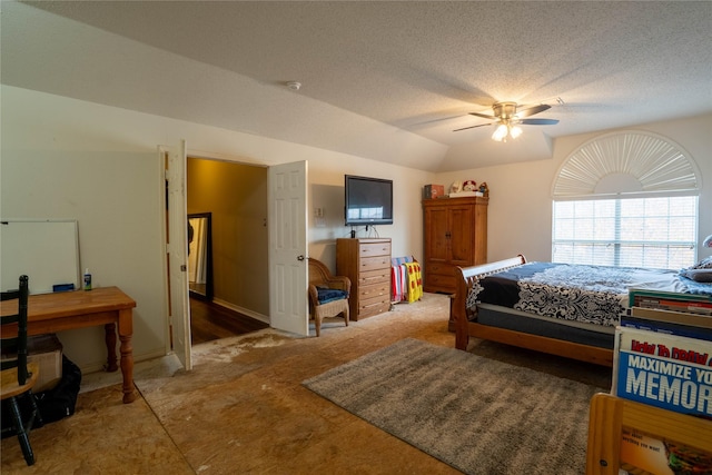 bedroom with a textured ceiling, ceiling fan, and lofted ceiling