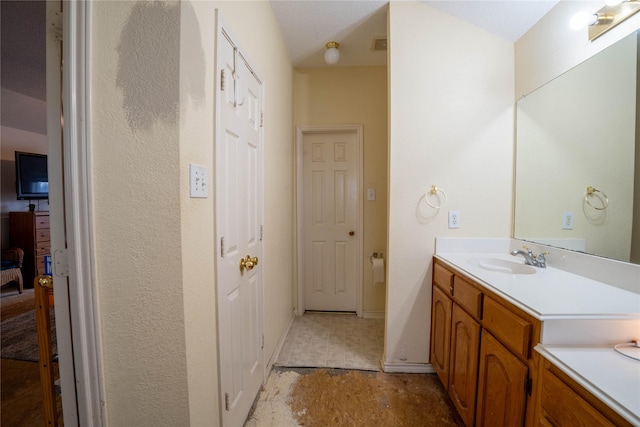 bathroom with vanity and lofted ceiling