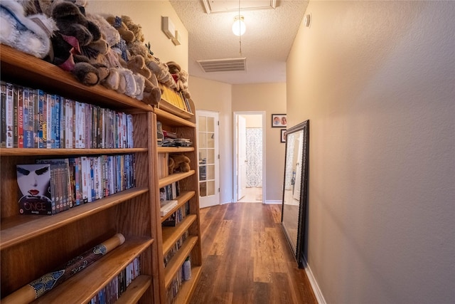 hallway featuring hardwood / wood-style floors and a textured ceiling