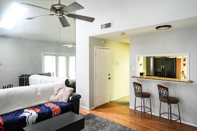 living room with light wood-type flooring and ceiling fan