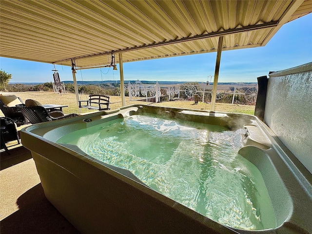 view of swimming pool featuring a hot tub