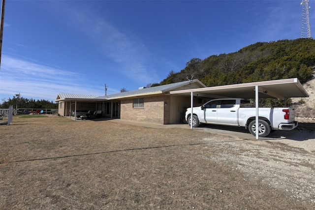 view of side of property with a carport