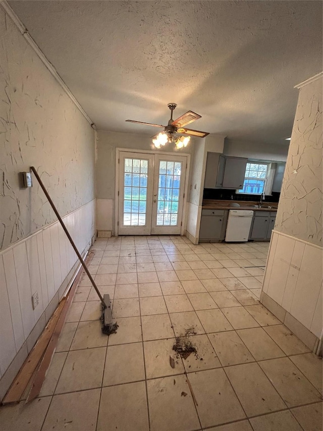 interior space featuring gray cabinetry, french doors, sink, white dishwasher, and a textured ceiling