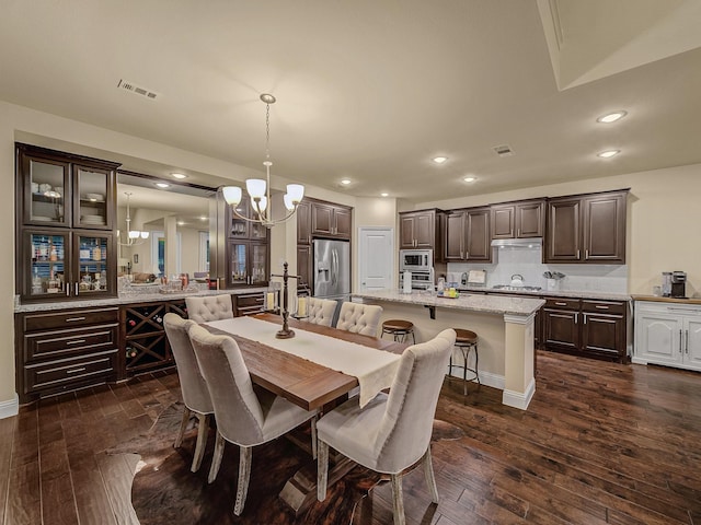 dining room featuring dark wood-type flooring and a notable chandelier