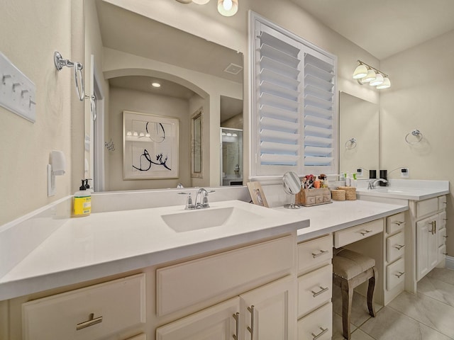 bathroom with vanity, a shower with door, and tile patterned flooring