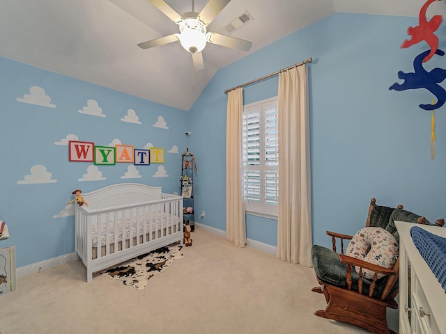 carpeted bedroom featuring vaulted ceiling, a nursery area, and ceiling fan