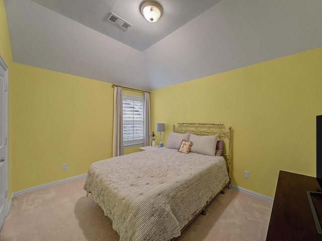 carpeted bedroom with lofted ceiling