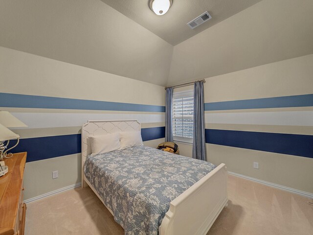 carpeted bedroom featuring lofted ceiling