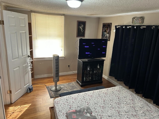 bedroom featuring wood-type flooring and a textured ceiling