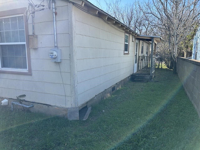 view of property exterior with a yard