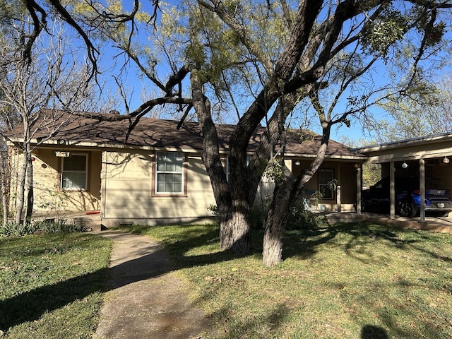 view of home's exterior with a carport and a lawn