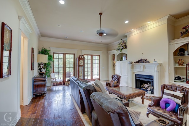 living room with dark wood-type flooring, ornamental molding, french doors, and ceiling fan