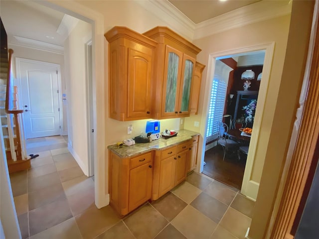 interior space featuring crown molding and light stone countertops