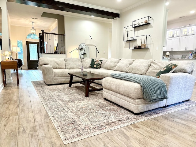 living room with hardwood / wood-style flooring, ornamental molding, and beamed ceiling