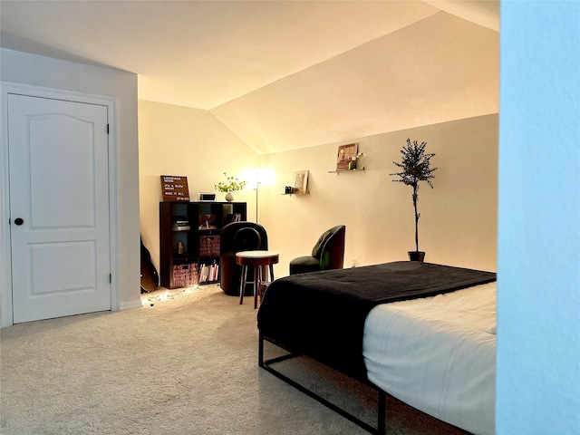 bedroom with carpet flooring and vaulted ceiling