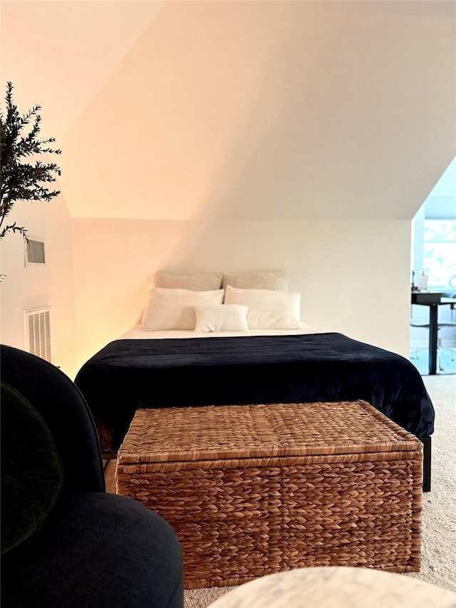 bedroom featuring lofted ceiling and carpet floors