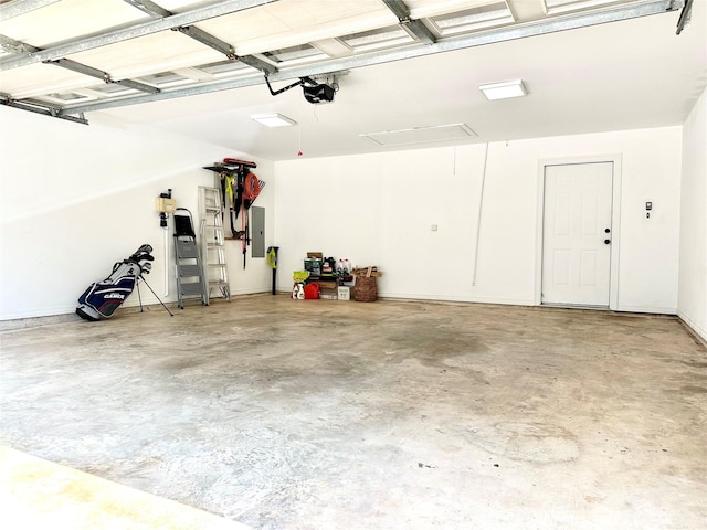 garage featuring electric panel and a garage door opener