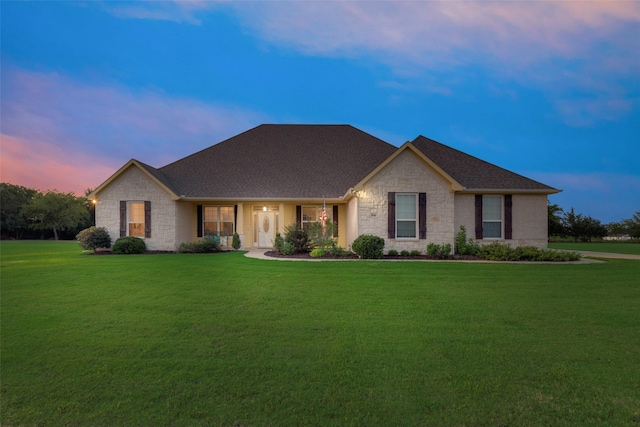 ranch-style house featuring a lawn