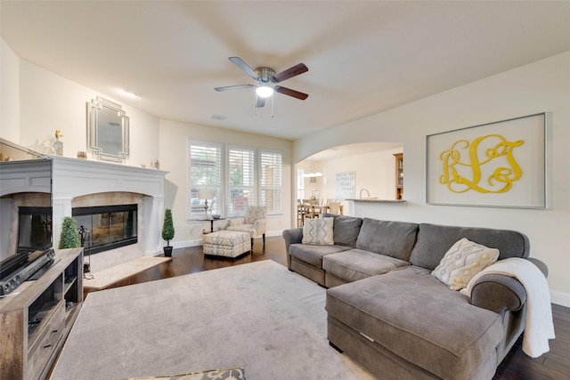 living room with dark hardwood / wood-style flooring and ceiling fan