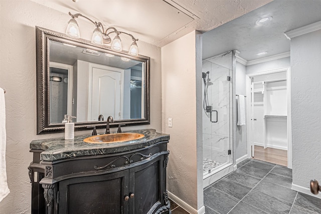 bathroom with tile patterned floors, crown molding, vanity, and an enclosed shower