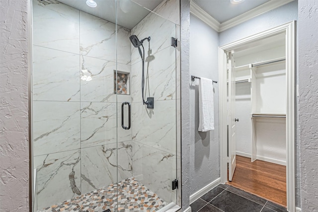 bathroom with tile patterned floors, crown molding, and an enclosed shower