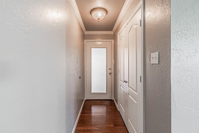 hall with baseboards, a textured wall, dark wood-style flooring, and crown molding