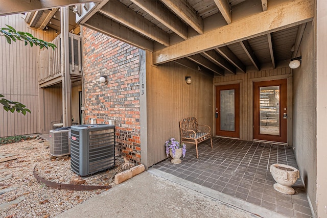 property entrance featuring cooling unit and a patio area