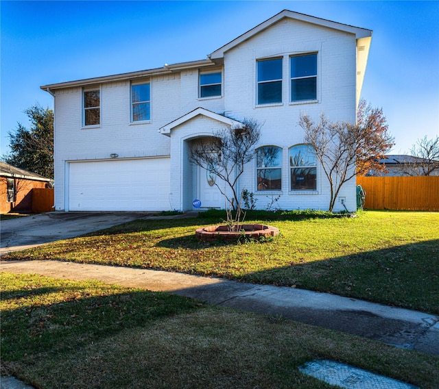 view of front of house with a front yard and a garage