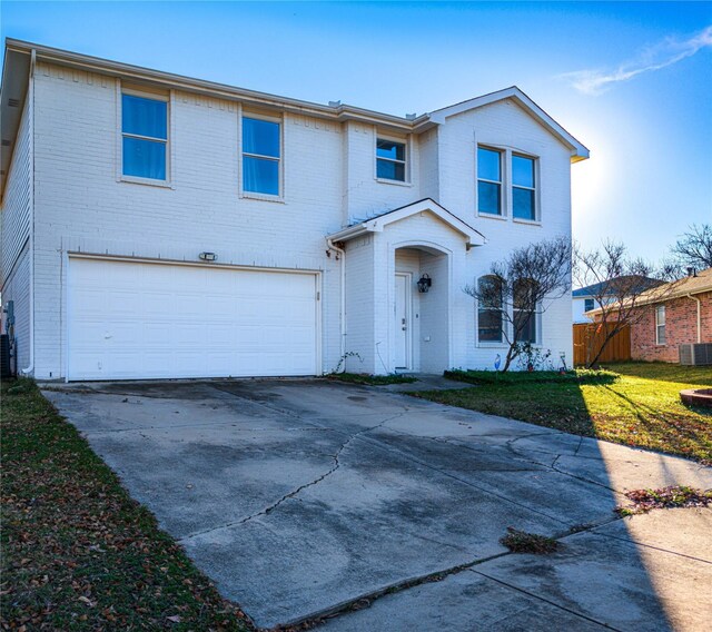 view of front property featuring a front yard and a garage