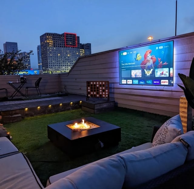 exterior space featuring an outdoor living space with a fire pit