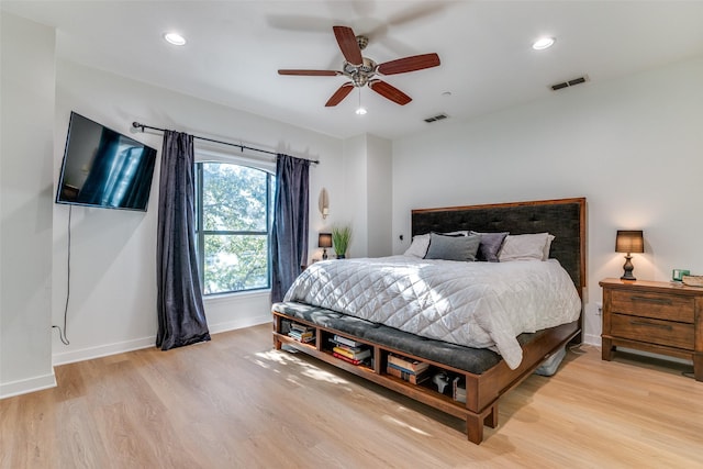 bedroom with ceiling fan and light hardwood / wood-style flooring