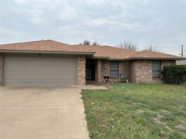 single story home with a garage and a front lawn