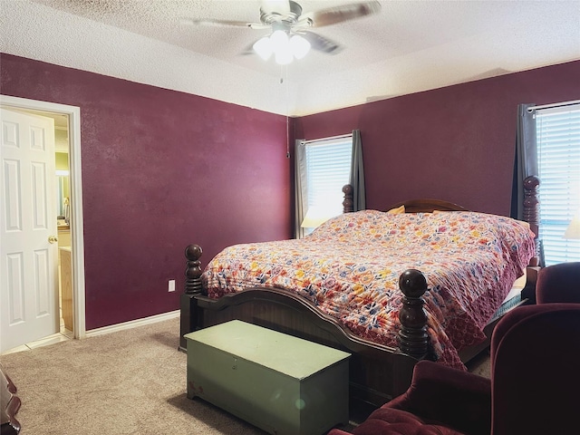 bedroom with carpet, ceiling fan, and a textured ceiling