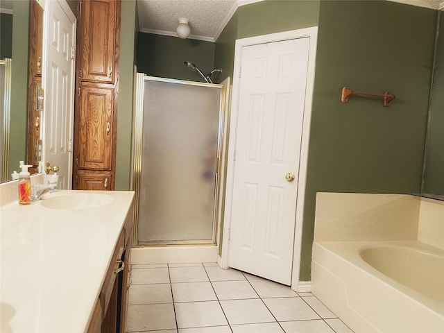 bathroom featuring vanity, a textured ceiling, tile patterned floors, and separate shower and tub