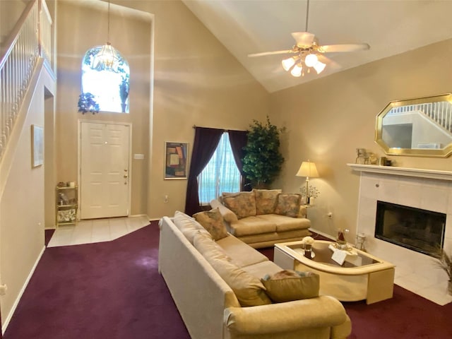 carpeted living room with ceiling fan, a wealth of natural light, a fireplace, and high vaulted ceiling