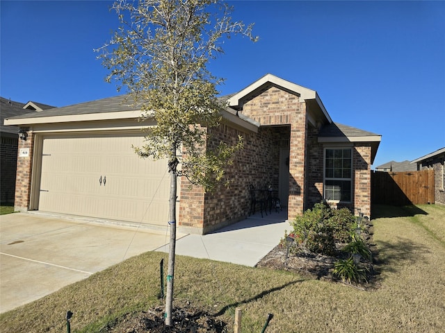 view of front of house with a garage and a front yard