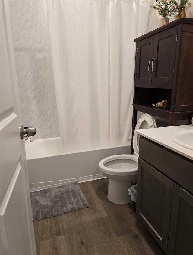 full bathroom with vanity, hardwood / wood-style floors, shower / bath combination with curtain, and toilet