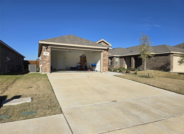 view of front of home with central AC, a front lawn, and a garage