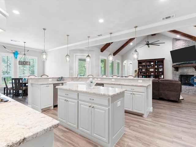 kitchen featuring a spacious island, dishwasher, and hanging light fixtures