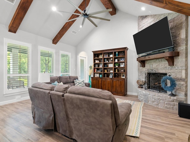 living room featuring light hardwood / wood-style flooring, a fireplace, high vaulted ceiling, and beamed ceiling