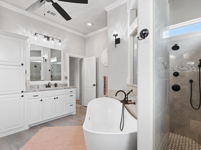 bathroom with ceiling fan, ornamental molding, shower with separate bathtub, and vanity