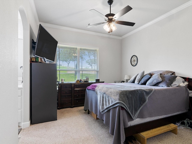 bedroom featuring light carpet, crown molding, and ceiling fan