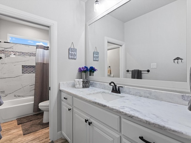 full bathroom with vanity, shower / tub combo, hardwood / wood-style flooring, and toilet