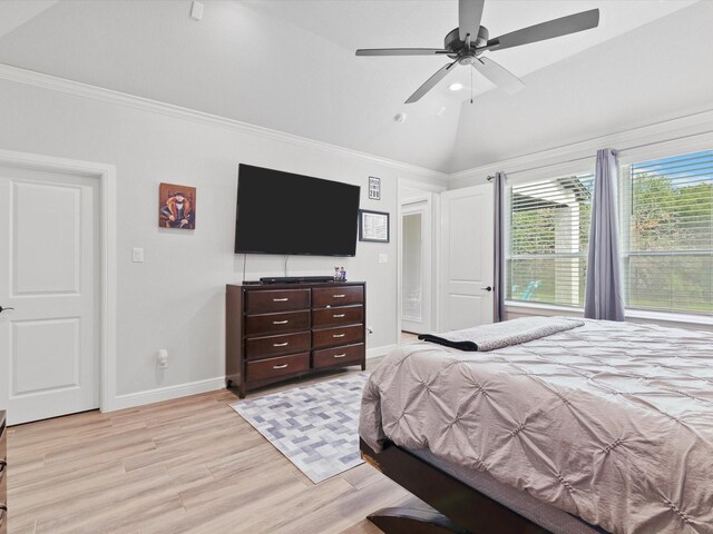 bedroom featuring vaulted ceiling, ornamental molding, ceiling fan, and light hardwood / wood-style floors