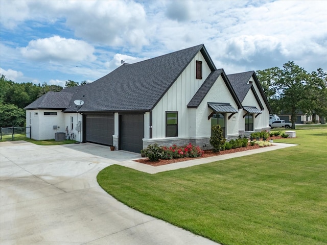 view of front of house featuring a garage and a front lawn